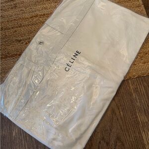 CÉLINE White garment bag with hanger loop hole for hanging